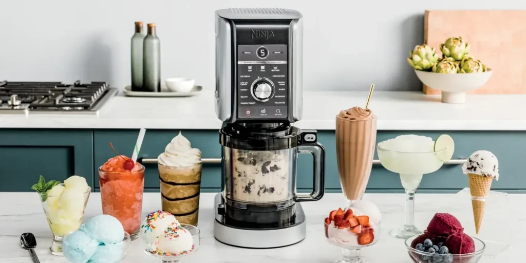 An advanced Ninja Creami machine displayed on a modern kitchen countertop, surrounded by various desserts like ice cream, milkshakes, sorbet, and gelato in colorful glasses and bowls